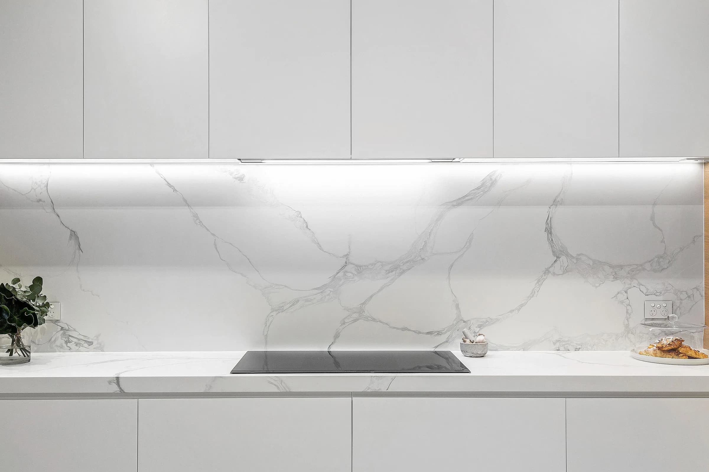 White joinery kitchen with marble slab splashback