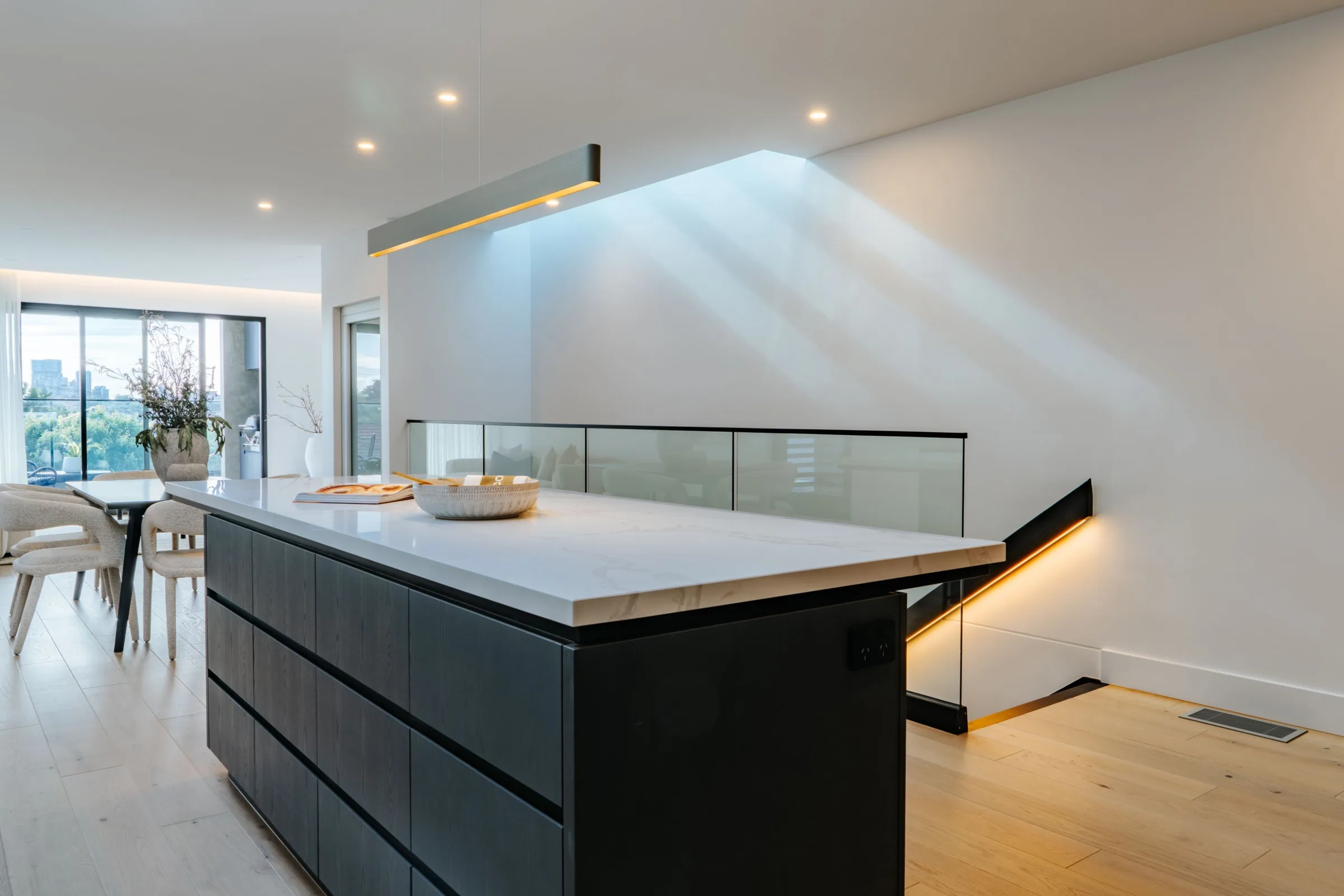 Kitchen island in morning light with stone waterfall edge