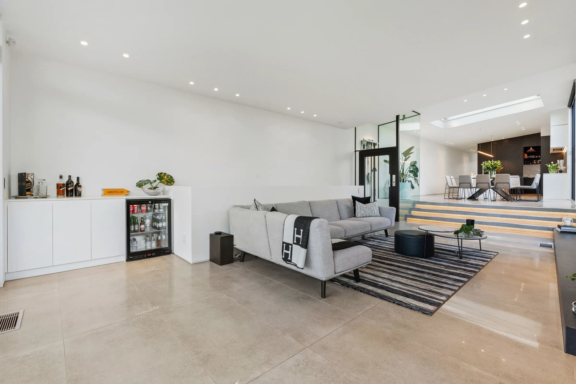 Renovated open-plan living space with polished concrete floor