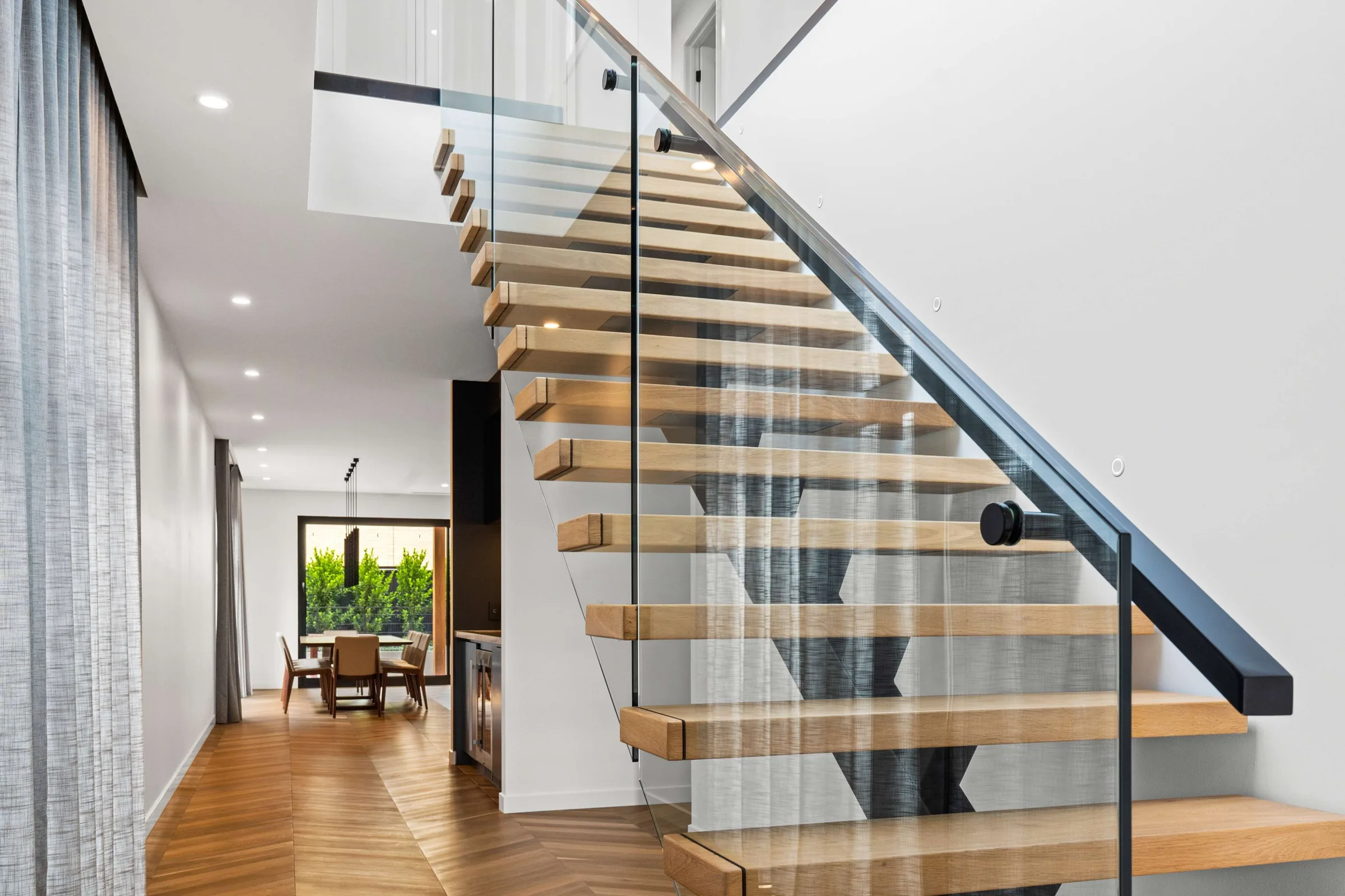 Floating oak stair treads with glass balustrade
