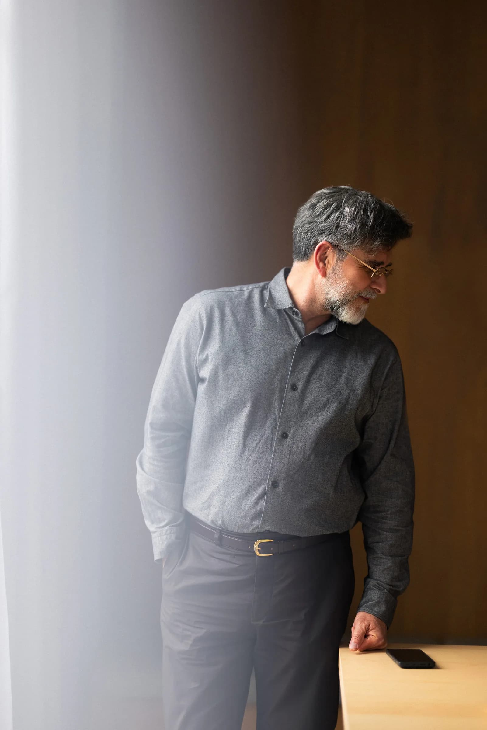 Terry standing in a dark timber-panelled hallway of a completed build
