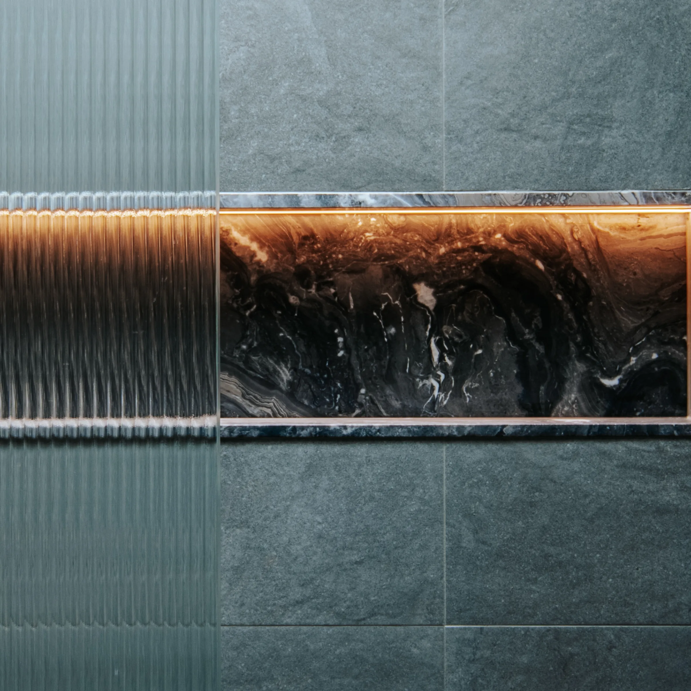 Fluted glass and dark stone joinery detail
