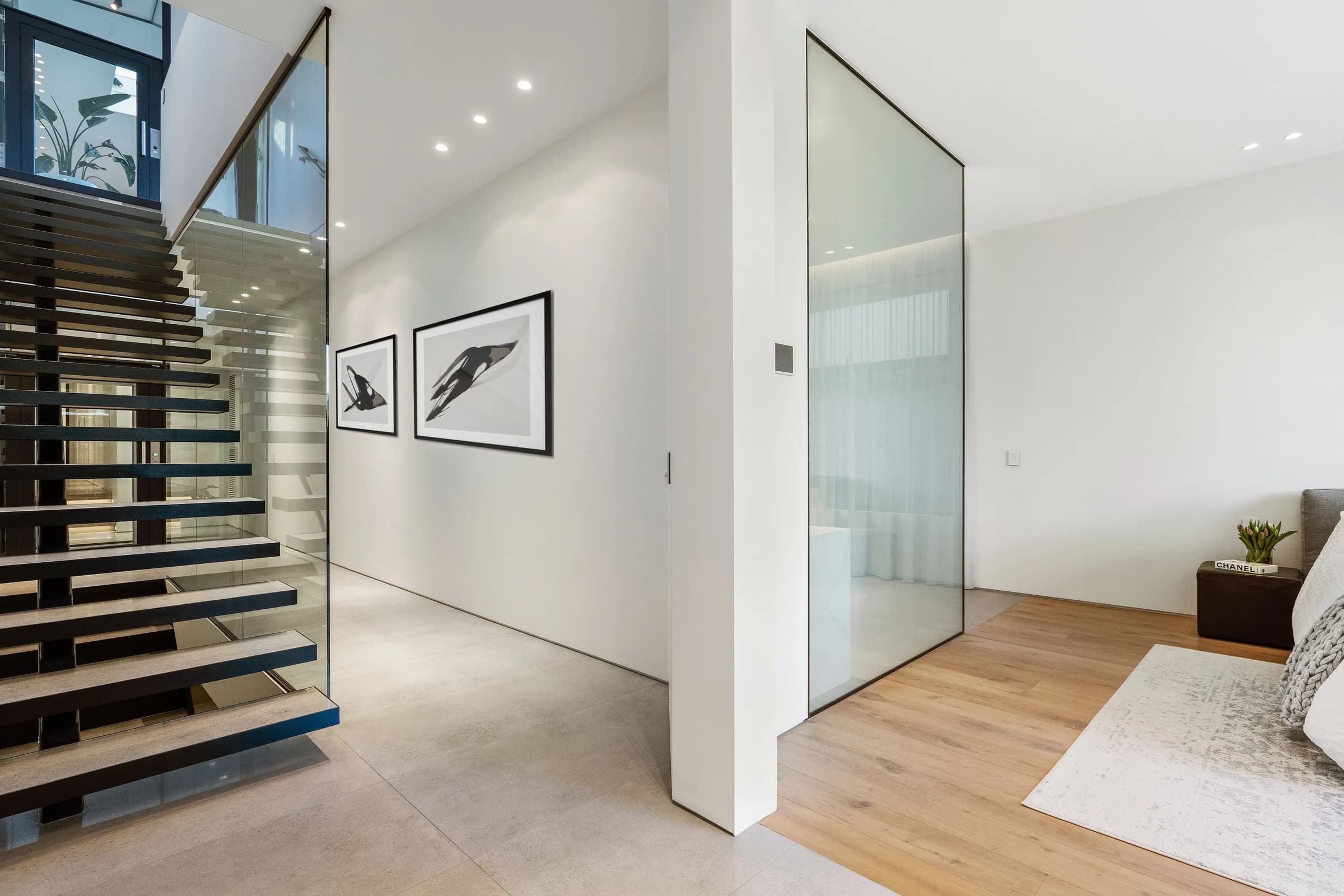 Hallway with floating stair and framed artwork