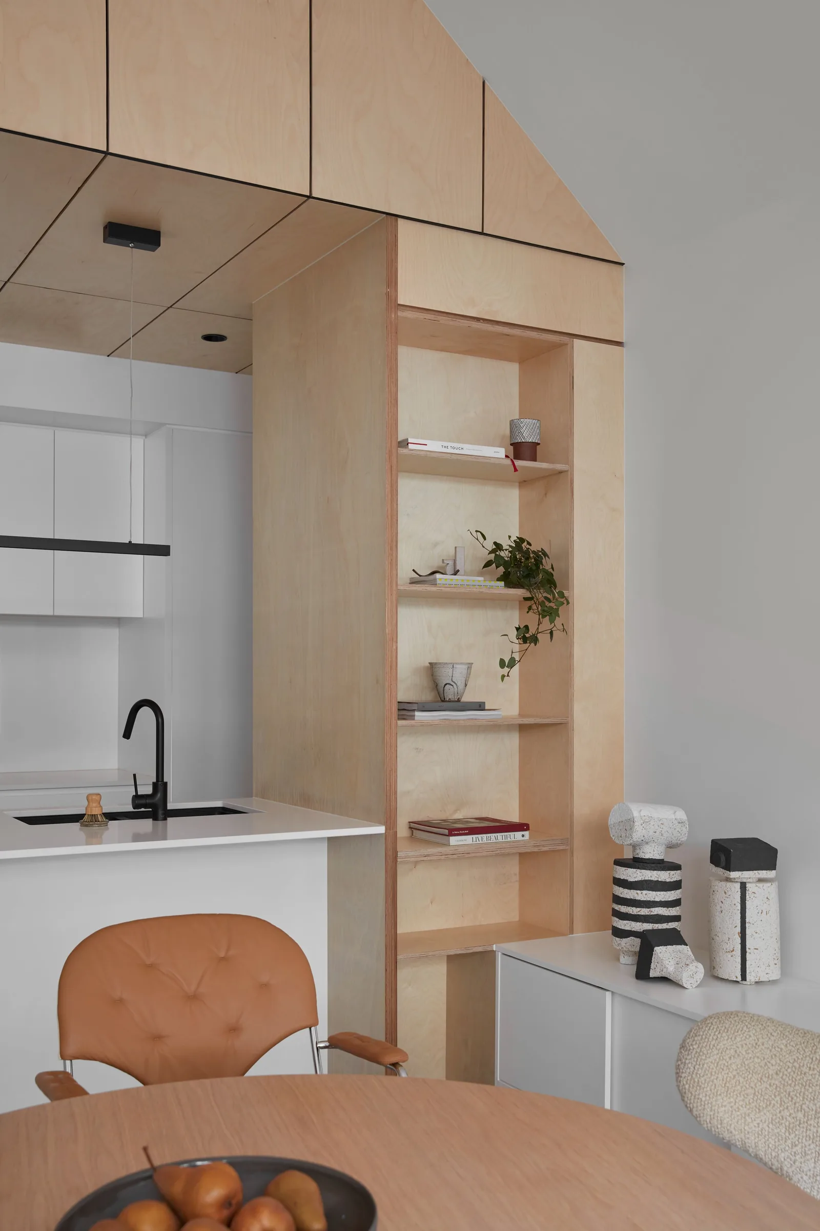 Plywood kitchen joinery with island table and pendant lighting